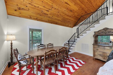 Dining area with wooden ceiling, dark hardwood / w