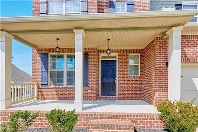 Doorway to property with covered porch and a garag
