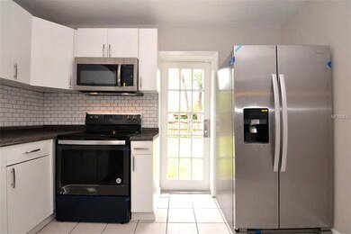 Kitchen with french door leading to the fenced bac