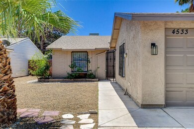 View of exterior entry with stucco siding, roof wi
