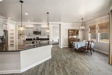 Kitchen featuring a notable chandelier, baseboards