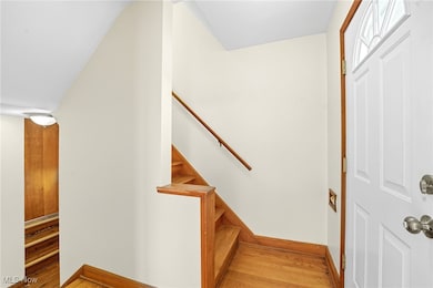 Entrance foyer with light wood-type flooring and stairway