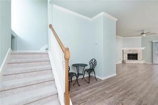 Staircase featuring a ceiling fan, wood finished 