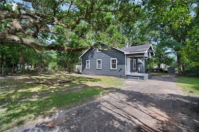 View of side of property with asphalt driveway