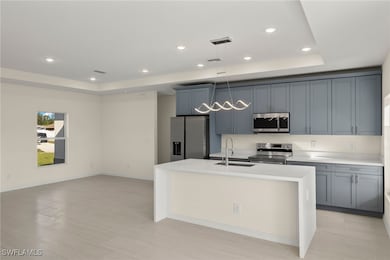 Kitchen with sink, appliances with stainless steel