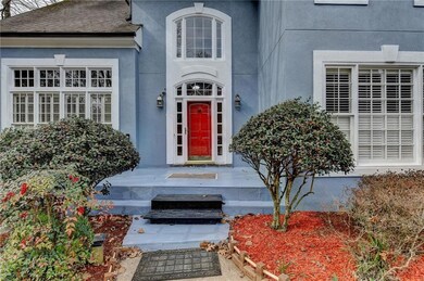 View of exterior entry with roof with shingles and
