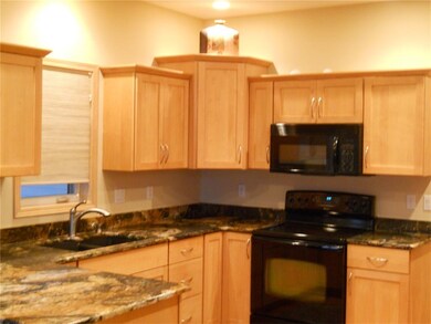 The fully appointed gourmet kitchen features newly