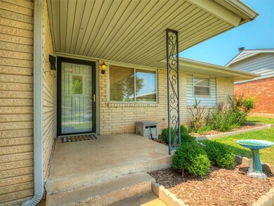 Property entrance with brick siding and covered porch