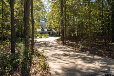 Long driveway curves around to side entry 3 car ga