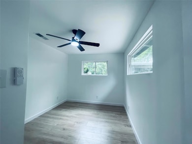 Spare room with light wood-style floors and baseboards