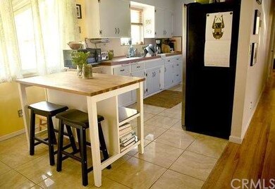 Large tile in kitchen and gleaming hardwood floori