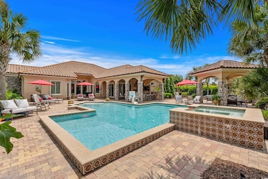 Swimming pool featuring an in-ground hot tub, outdoor lounge area, and a patio
