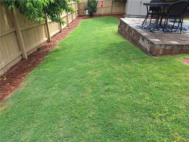 View of yard with a fenced backyard and a patio ar