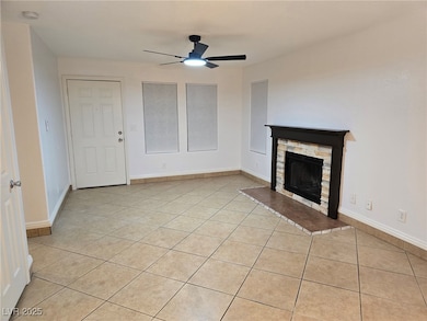 Unfurnished living room featuring light tile patte