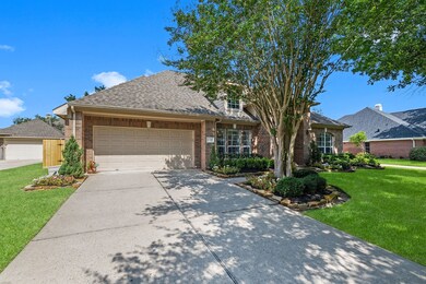 Long, double-wide driveway leading to the 3-car-tandem garage. Full gutters along the front.