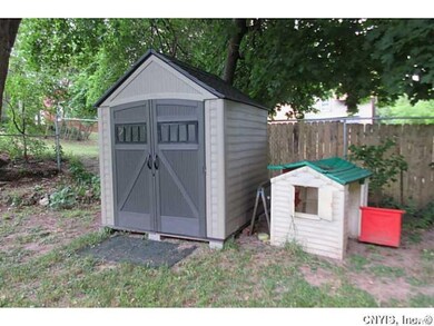 Vinyl storage shed in yard.
