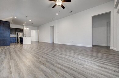Unfurnished living room with ceiling fan, recesse