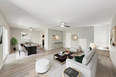 Living area with a ceiling fan, light wood-style 