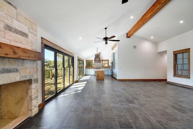 Unfurnished living room featuring recessed lighting, beamed ceiling, high vaulted ceiling, dark wood finished floors, and ceiling fan