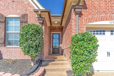 View of exterior entry featuring brick siding