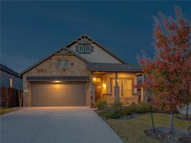 View of front of home with stone siding, driveway