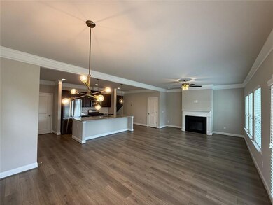 Unfurnished living room featuring ceiling fan, a f
