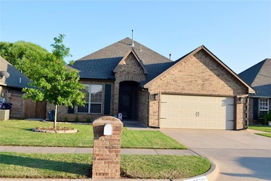 French country inspired facade featuring a garage, brick siding, concrete driveway, and a shingled roof