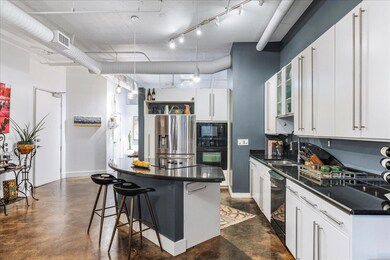 Kitchen featuring black appliances, dark countert