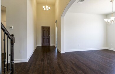 Welcoming foyer entry with two story ceilings and 