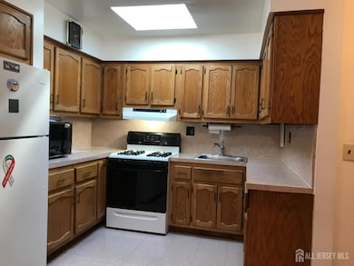 Well lit kitchen with plenty cabinetry