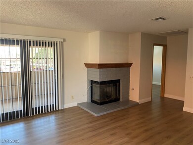 Unfurnished living room featuring a textured ceili