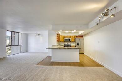 Kitchen with stainless steel appliances, light col