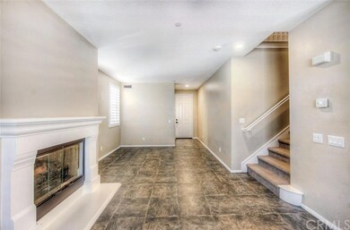 Fireplace and front door entry in to living room.
