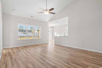 Unfurnished living room with ceiling fan with nota