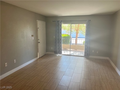 Living room featuring baseboards and wood tiled fl