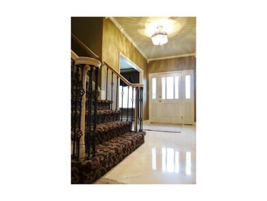 This Beautiful Entryway Features Italian Marble Flooring, Designer Chandelier, Access to the Formal Dining Room & Large Staircase with Iron Spindles & Well Maintained Carpeting.