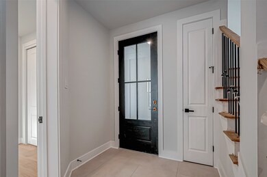 This photo shows a modern entryway with a sleek bl