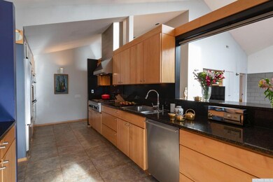 The kitchen with the large window opening to the l
