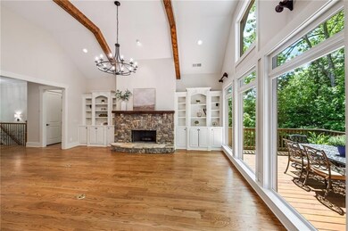 Unfurnished living room featuring high vaulted cei