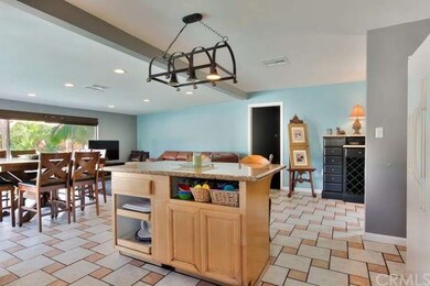Wrought-iron chandelier above your island and brea