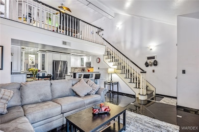 Living room featuring tile patterned floors, ceiling fan, beam ceiling, and high vaulted ceiling