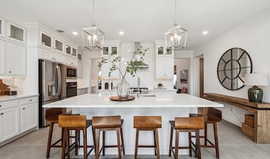 Kitchen with stacked glass-front upper cabinets over solid lowers