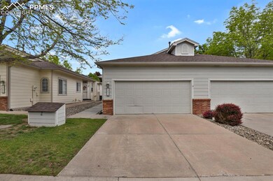 View of front of house with brick siding, concrete driveway, a front yard