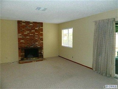 Living room has brick fireplace