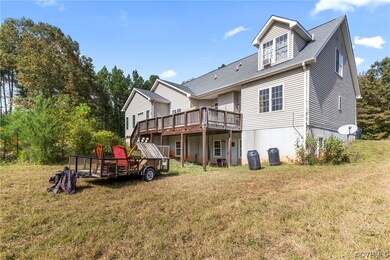 Back of property featuring a lawn and a deck