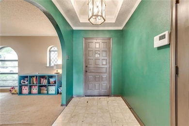 A bright entry with a trayed ceiling