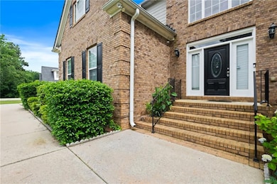 Traditional-style house with brick siding and a front yard