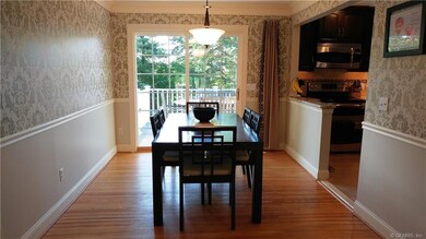 Dining Room off kitchen and open to living room; also features a sliding door to deck.