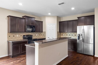 Kitchen with dark hardwood / wood-style floors, bl