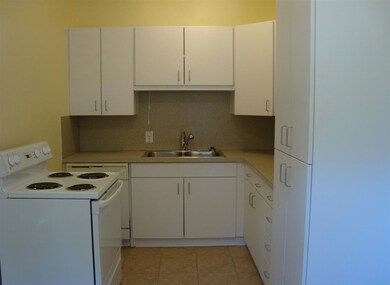 Bright white kitchen with adjoining eat-in space